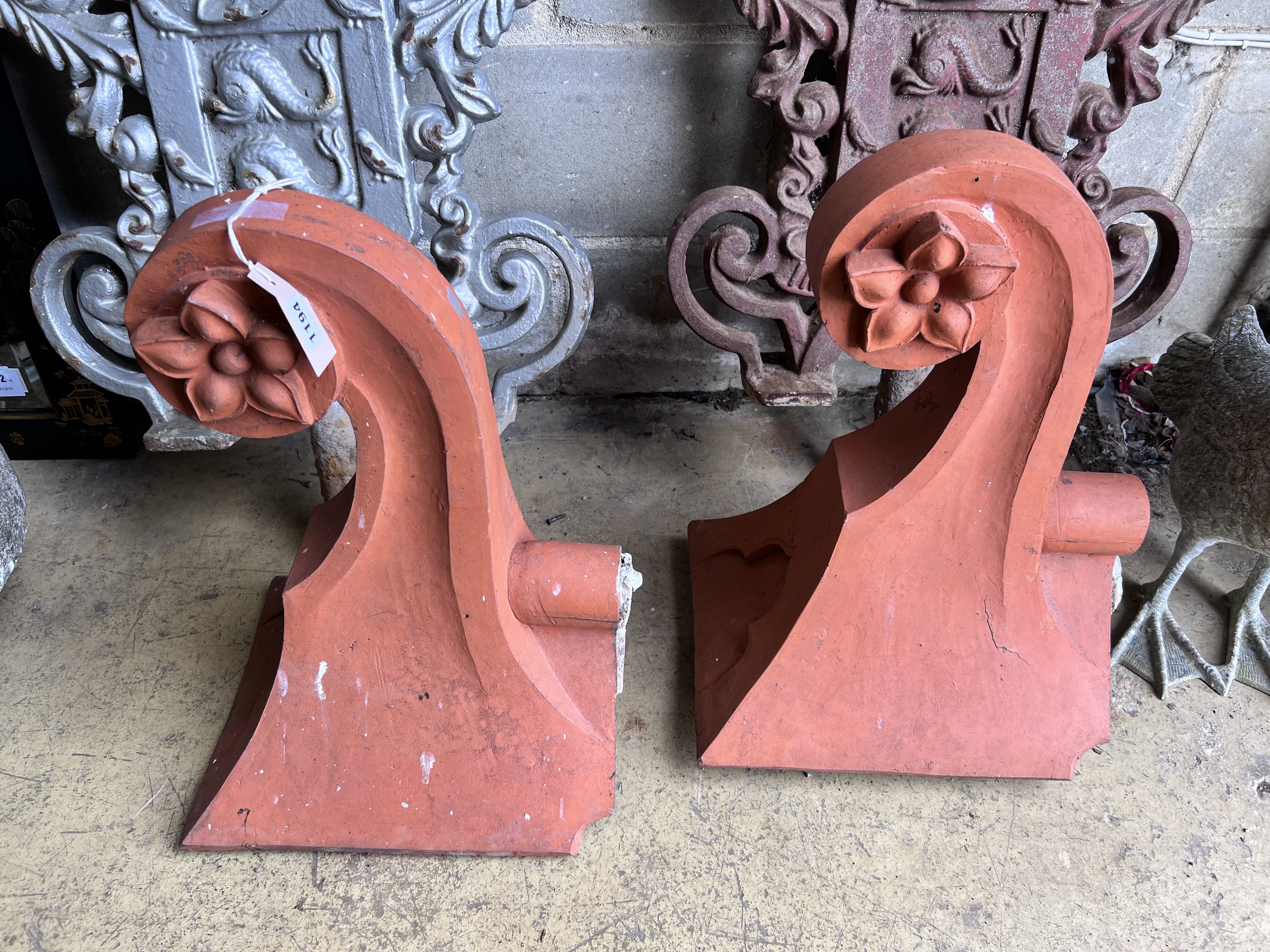 A pair of Victorian terracotta roof tile finials, height 53cm